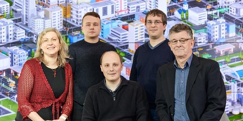 The image shows five people who are working for the University of Leeds spinout company, Slingshot Communications.