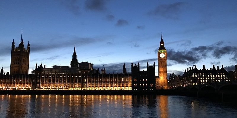 The image is taken from the south side of the River Thames showing the Houses of Parliament across the water. The picture is taken at night.