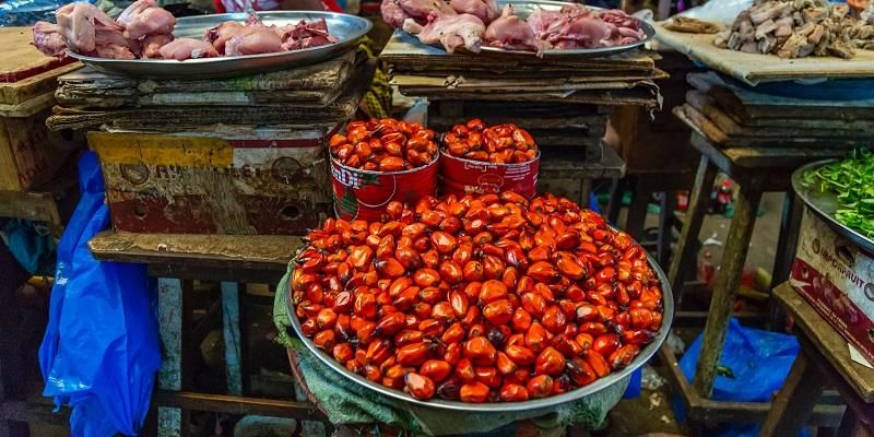 The images show colourful food produce on display in an African market
