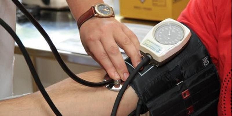 Picture shows someone having their blood pressure recorded