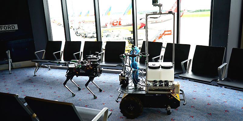 Two robots in a passenger lounge in Leeds Bradford Airport.