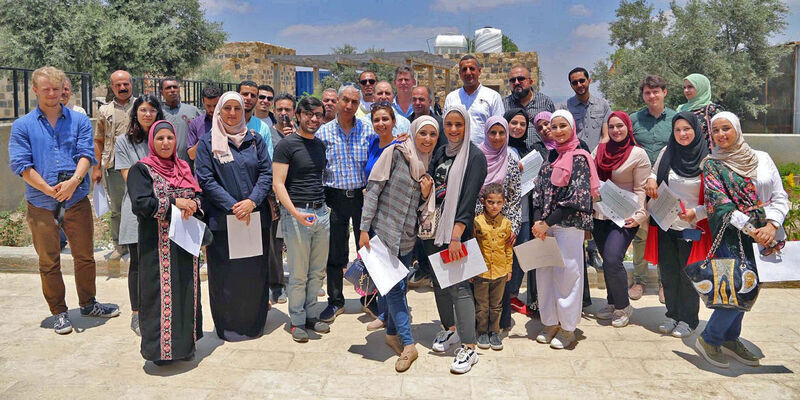 A group of researchers and students in the ancient site of Umm Qais.