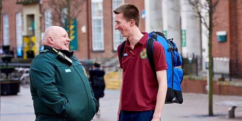 A medical student talking to a Community Defibrillation Officer from Yorkshire Ambulance Service outside Leeds University Union.