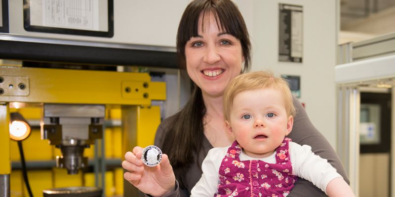 Image shows Dr Emma Cavell with her daughter, Edith (named after her famous forebear) and the commemorative coin minted earlier this year to honour the memory of their relative, Nurse Edith Cavell. Credit: The Royal Mint.