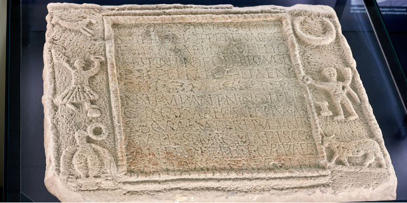 Close-up of ancient manuscript stone on display in Michael Sadler Building
