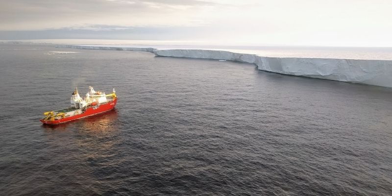 Image of boat in ocean surrounded by water and glaciers