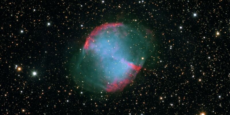 The Dumbbell Nebula against a backdrop of stars and planets in space