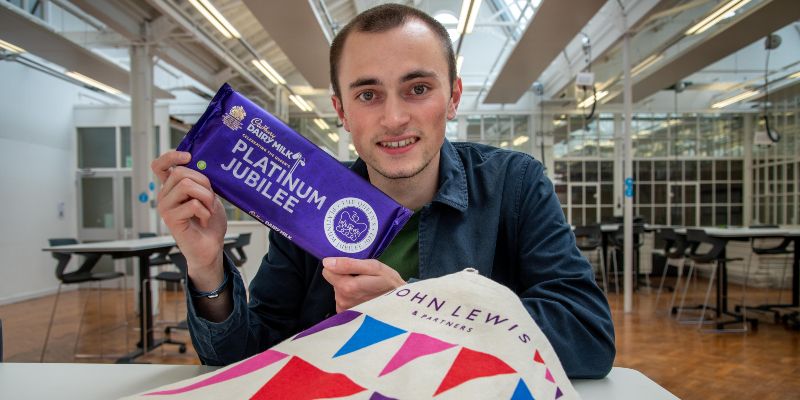 Edward Roberts holding a a bar of Dairy Milk chocolate with his Platinum Jubilee design on the wrapper