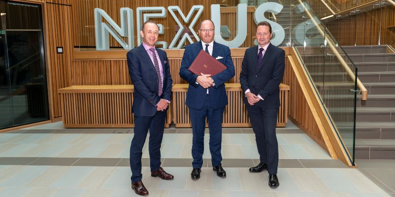 From left, Professor Nick Plant, Science Minister George Freeman and Dr Martin Stow standing in front of the Nexus logo in the building foyer