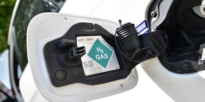 An open fuel cap on a vehicle with a label that shows the vehicles runs on hydrogen