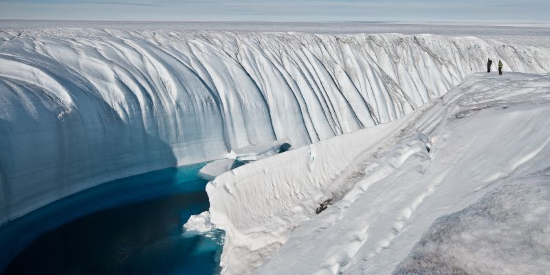 Surface meltwater flowing towards the ocean through a channel in Greenland
