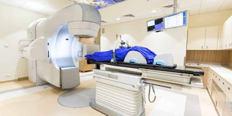 A radiotherapy machine in a hospital treatment room,