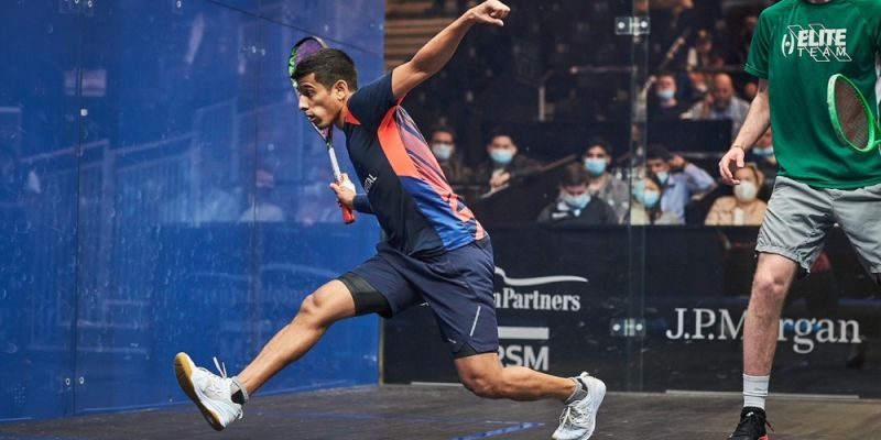 Saurav Ghosal playing squash, swings his racket on court