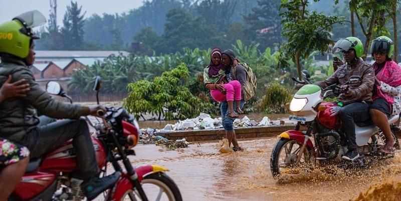 Pedestrians and motorist risking their lives to transport passengers in a flooded road in Kigali on 28 January 2020. Photo by Emmanuel Kwizera.