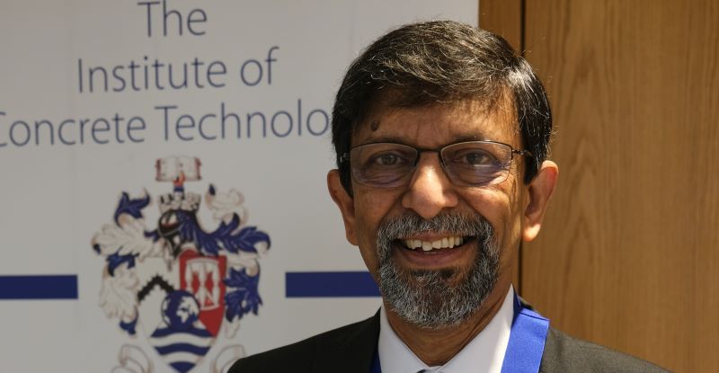 An image of Professor Basheer, smiling and wearing a suit
