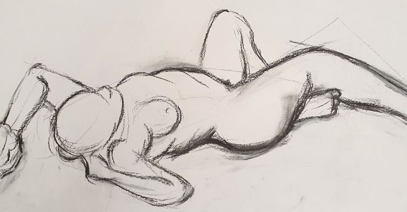 Life drawing of a nude model reclining